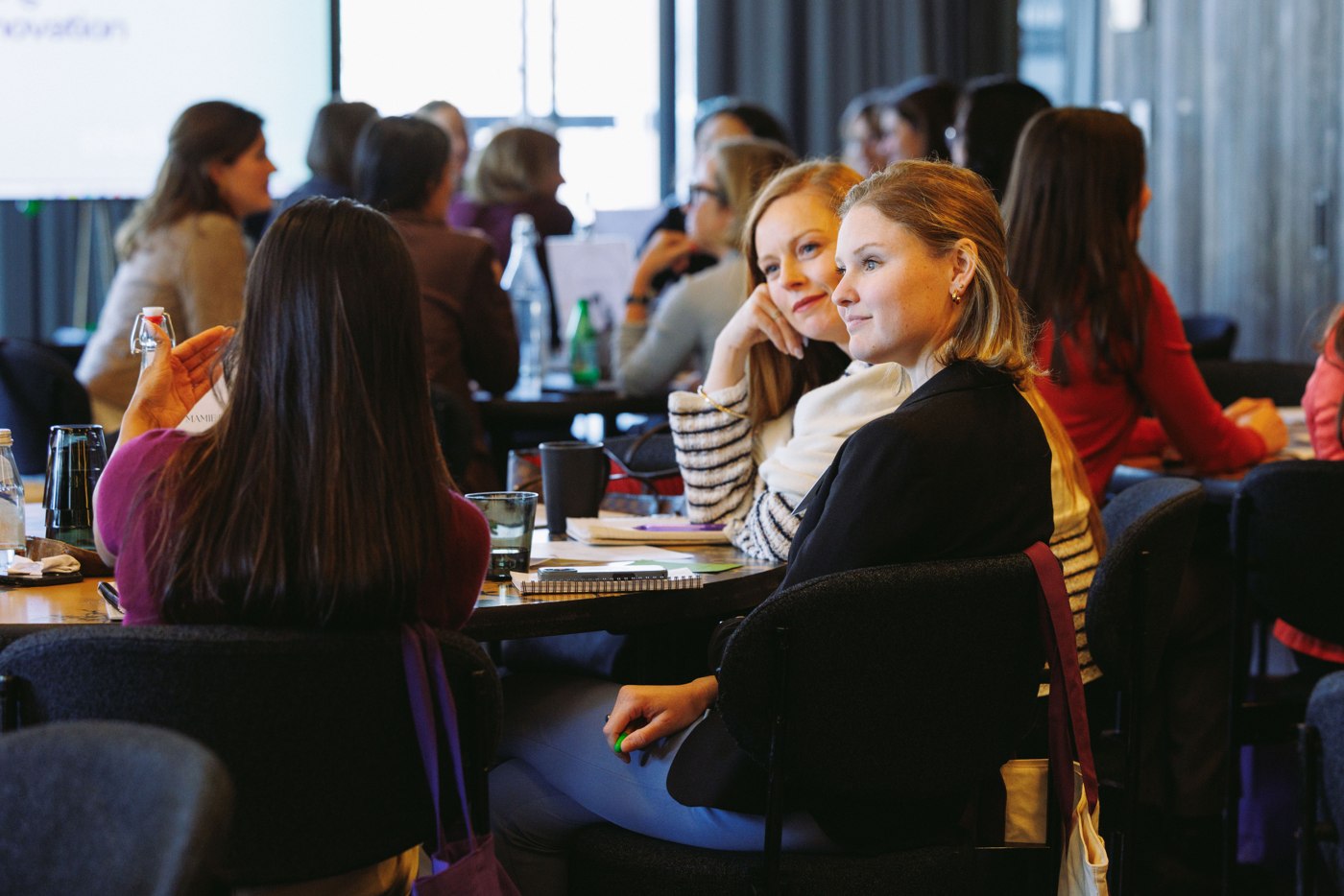 Women exchanging ideas around a Summit table