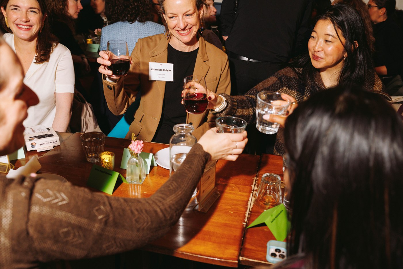 Women raising a toast together at the Summit