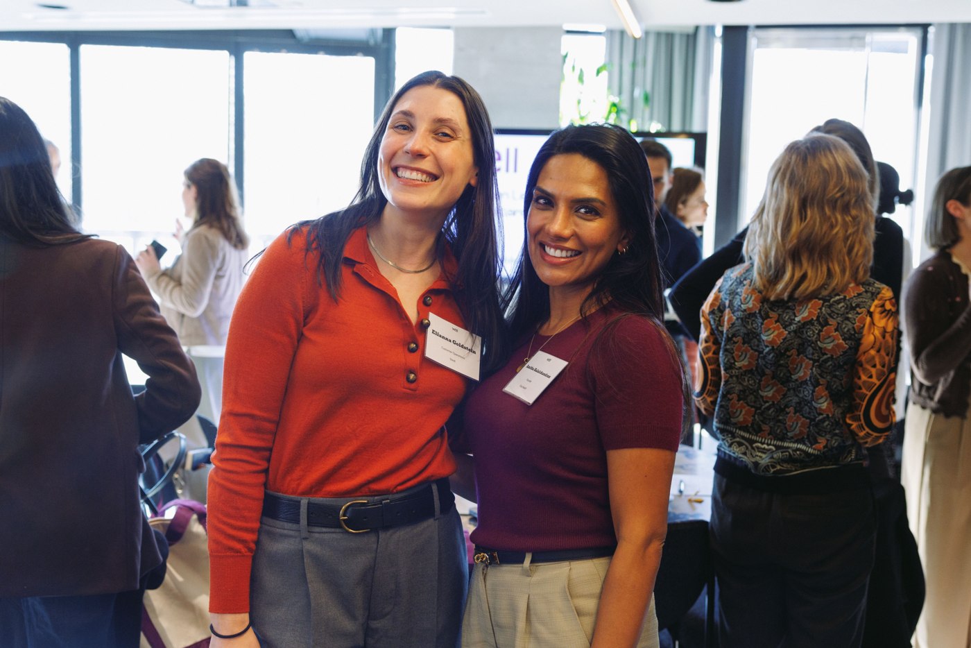 Two WELL Summit attendees smiling together