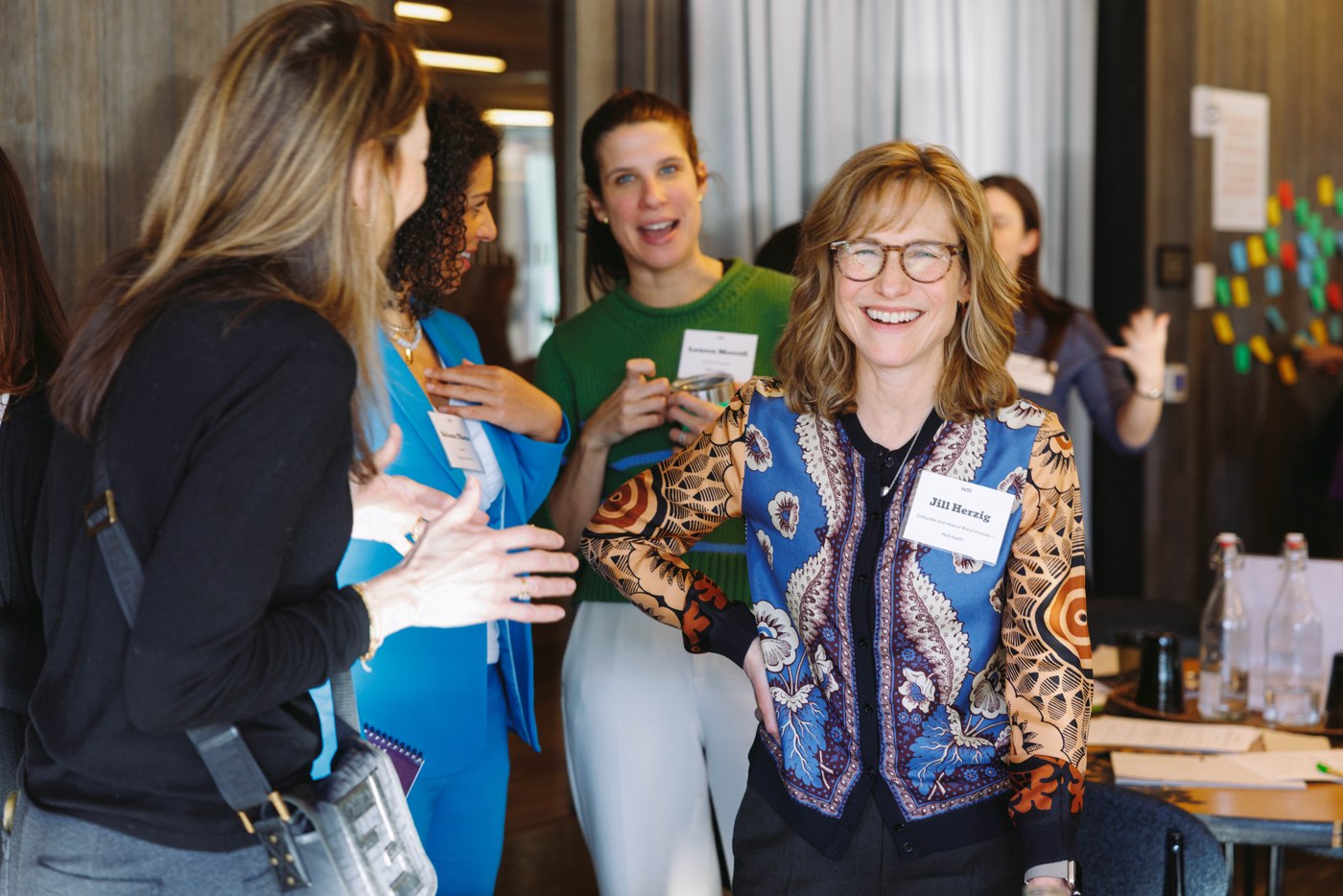 WELL members sharing a conversation at a reception
