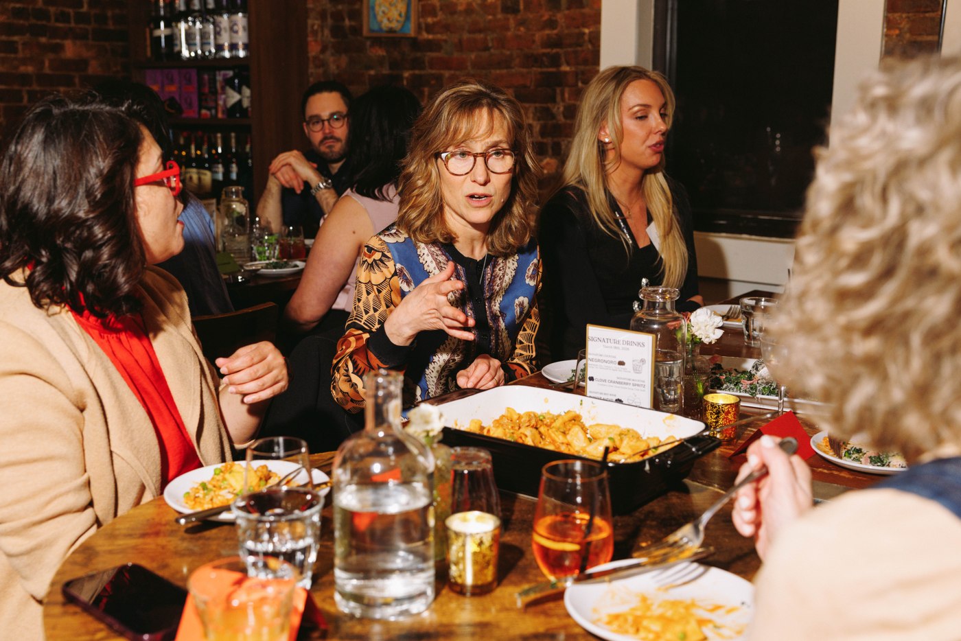 Members laughing together over dinner